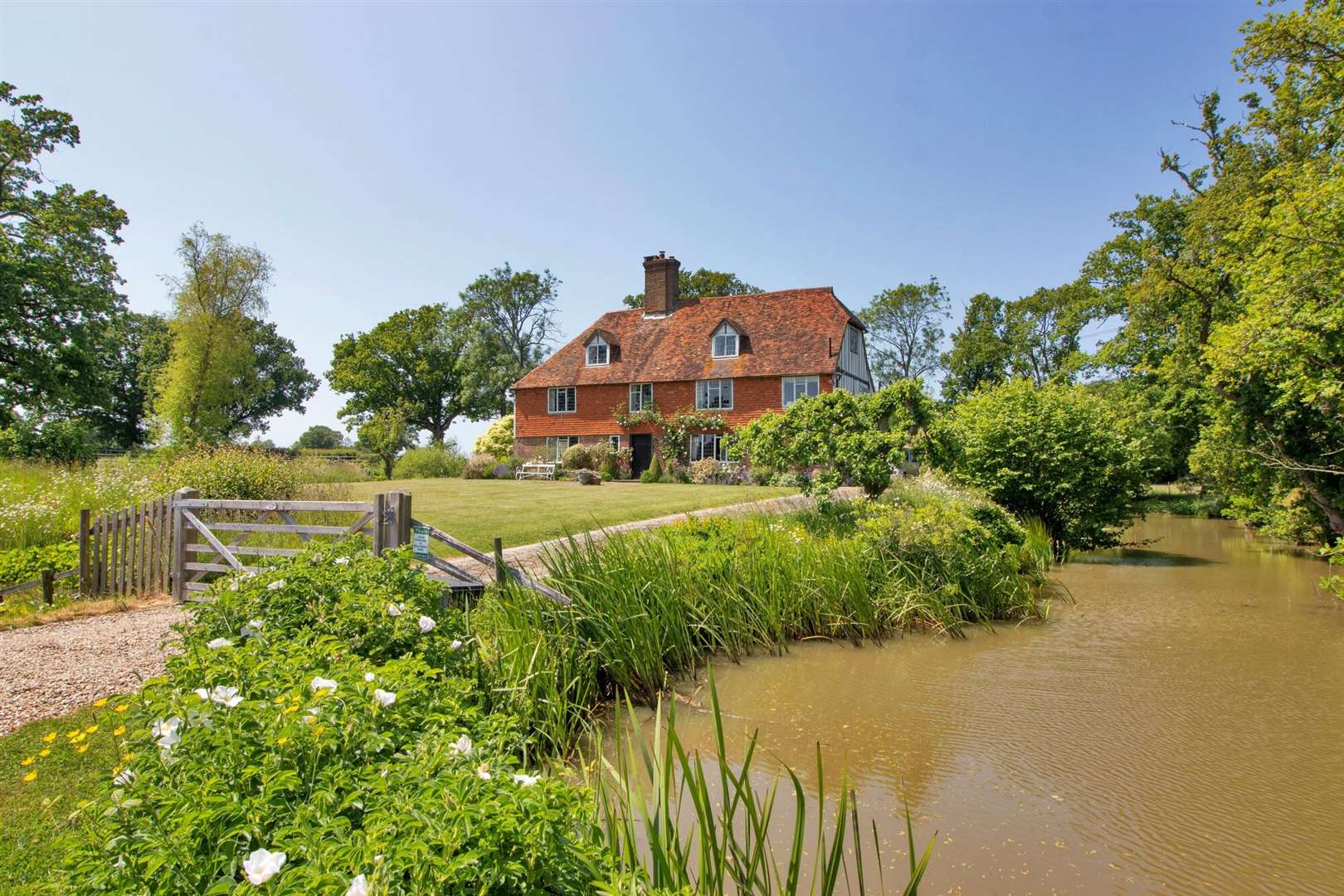 The six-bedroom manor on the outskirts of Biddenden, near Tenterden, is surrounded by a moat